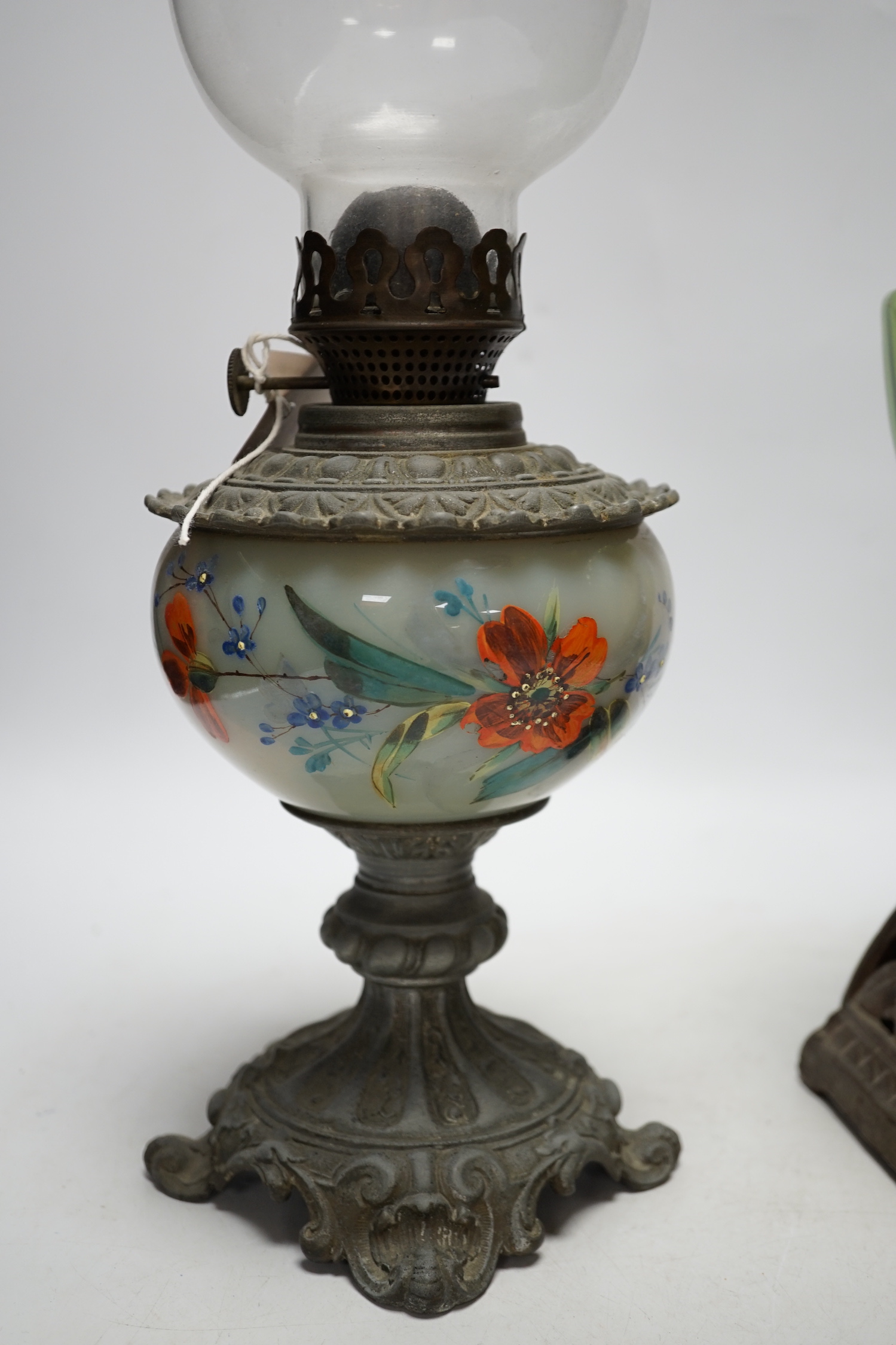 Two oil lamp bases with glass reservoirs, largest 48cm high